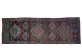 Vintage Oushak rug runner, distressed, with geometric diamond pattern in charcoal, blue, and green.
