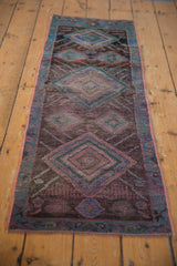 Distressed Oushak runner, showing worn pile, geometric motifs, and prominent pink selvage.