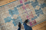 Vintage distressed Oushak runner showcasing worn denim blue, beige, and fuchsia floral motifs.