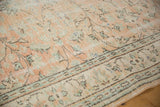 Patinaed texture of distressed Oushak rug, showing apricot vinery and green border.