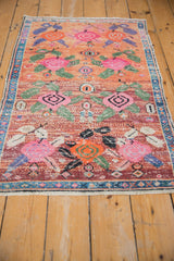 Whimsical floral patterns and rich abrash texture on a distressed vintage Oushak rug.