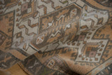 Distressed short pile and geometric shapes on a vintage Oushak rug in neutral tones.