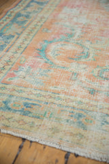 Distressed Oushak pile showing wear to knot heads in apricot and pale blue.