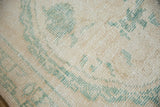 Distressed Oushak rug pile detail, showing wear to foundation and knot heads with seafoam green.
