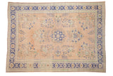 Vintage distressed Oushak carpet, apricot field, cobalt blue medallion, floral sprays.