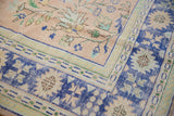 Visible abrashes on the cobalt blue main border of a vintage Oushak carpet.