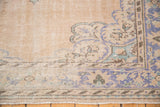 Vintage distressed Oushak rug corner: faded blue, seafoam green floral motifs, visible wear.