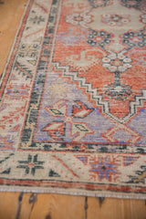 Texture and even wear on brick red, pale blue, and ivory stepped geometric patterns.