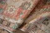 Distressed vintage Oushak rug runner with faded cherry red, ivory, and turquoise texture.
