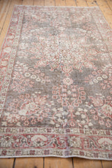 Distressed Sparta rug's worn pile, foundation showing through oxidized silver and cherry florals.