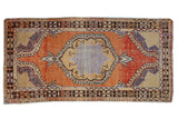 Vintage distressed Oushak runner with tangerine scalloped medallion and aubergine accents, 2'9