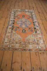 Distressed Oushak runner edge detail, featuring worn terracotta, blue, ivory, green patterns.