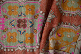 Vintage distressed Oushak runner's seafoam green, bubblegum pink, and saffron gold floral patterns.
