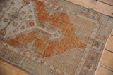 Distressed Oushak runner showing textured terracotta pile with faded ivory and silver geometric motifs.