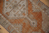 Terracotta and oxidized silver tones with visible knot heads and worn texture of an Oushak rug.