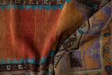 Distressed Oushak rug's textured pile in terracotta, turquoise, and geometric finned blossoms.
