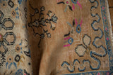 Distressed vintage Oushak rug with faded beige pile, blue, and bright pink curvilinear motifs.