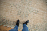 Distressed vintage Oushak rug texture with worn knot heads, faded ivory and seafoam green.