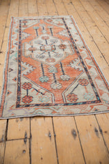 Distressed Vintage Oushak rug runner with meandering vine border, terracotta, ivory, and charcoal.