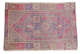 Vintage distressed Oushak rug, pink and aubergine medallion, faded floral patterns. 2'8