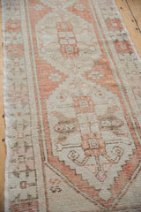 Distressed Oushak runner side, showing original selvage and geometric ivory and rust pattern.