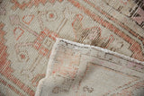 Distressed Oushak rug's worn hand-knotted pile and foundation, in pale rust, sandalwood, and ivory.