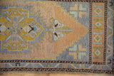 Distressed Oushak rug with even pile wear and pale blue, beige geometric contour.