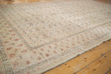 Decorative distressed texture of Oushak gul motifs in pale ivory, seafoam, and blush.