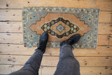 Distressed vintage Turkish Oushak rug with central pinwheel medallion and faded sandalwood, slate blue.
