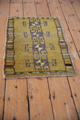 Kars rug corner showing distressed texture, geometric border blocks, and side cord selvage.