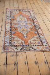 Vintage Oushak runner with distressed texture, tangerine, faded blue, ivory colors, and serrated motifs.