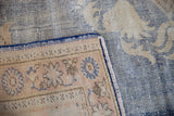 Close-up showing the hand-knotted foundation of a distressed Oushak carpet, denim blue and ivory.