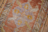 Distressed Oushak rug detail: worn burnt orange field, lavender medallion corner, and saffron palmette.