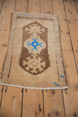 Vintage Distressed Oushak rug with blue geometric accents and abrashes on neutral field.