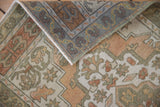 Distressed Oushak rug fold, highlighting even knot wear and soft copper, olive, ivory colors.