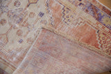 Distressed Oushak rug showing worn pile, natural fringe, and woven foundation.