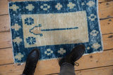 Vintage Distressed Oushak rug mat with textured pile, showing wear and faded blue tones.