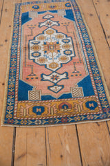 Distressed Oushak rug's starburst medallion and blossom border with even wear.
