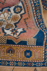 Vintage distressed Oushak rug textural fold with muted cobalt blue, sandalwood blossom patterns.