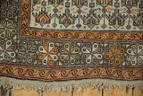 Original macrame fringe and tangerine wave motif border of the antique Caucasian rug.
