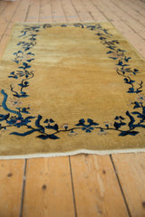 Art Deco runner's gold field, cobalt blue vinery, pale mauve blossoms, and side selvage.