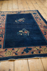Cobalt blue field of the Vintage Art Deco rug with floral motifs and visible knot heads.