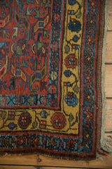 Vintage Kurdish Bijar rug corner, featuring rich saffron yellow floral border.