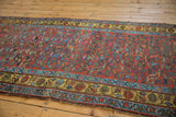 Diagonal view of a vintage Kurdish Bijar runner, with gem-tone spiraled floral field and saffron border.