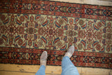 Detailed Herati motif on ivory ground of vintage Persian Hamadan runner, in wine red and indigo blue.