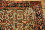 Vintage Hamadan runner Herati motif with ivory ground, sapphire blue, red, and visible foundation.