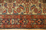 Detail of Vintage Hamadan rug with ivory ground Herati motif and a wine red geometric border.
