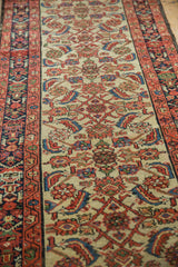 Intricate Herati motif on an ivory ground with patterned navy and wine red borders.