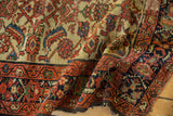 Folded vintage Hamadan runner showing mostly worn pile, indigo border, and unusual ivory Herati field.