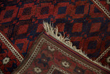 Folded corner of an antique Belouch rug revealing its plain weave back and original goat hair selvage.